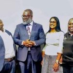 Caption ; DR Dagada standing alongside other delegates at the conference