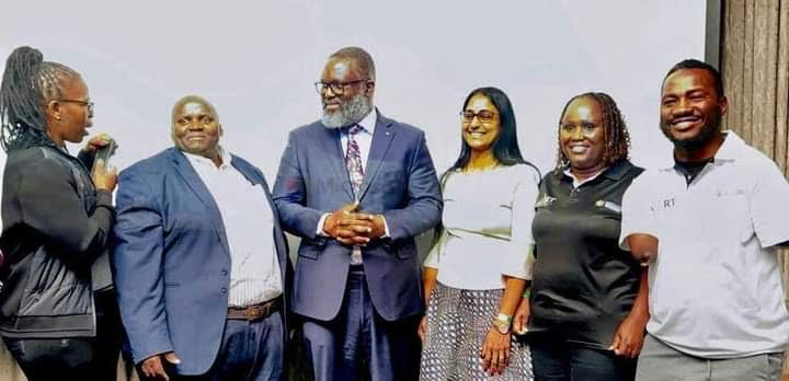 Caption ; DR Dagada standing alongside other delegates at the conference