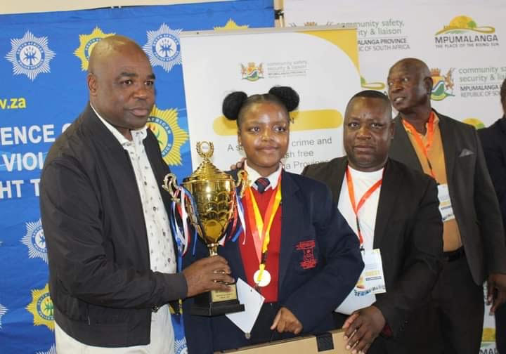 Caption; MEC Macie handing over a prize to one the learners